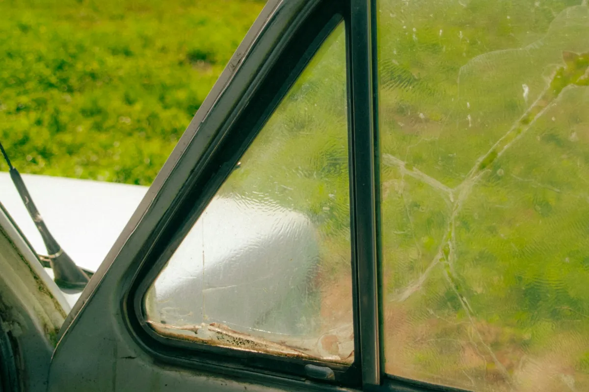 Cracked car side window waiting for replacement in Bowie